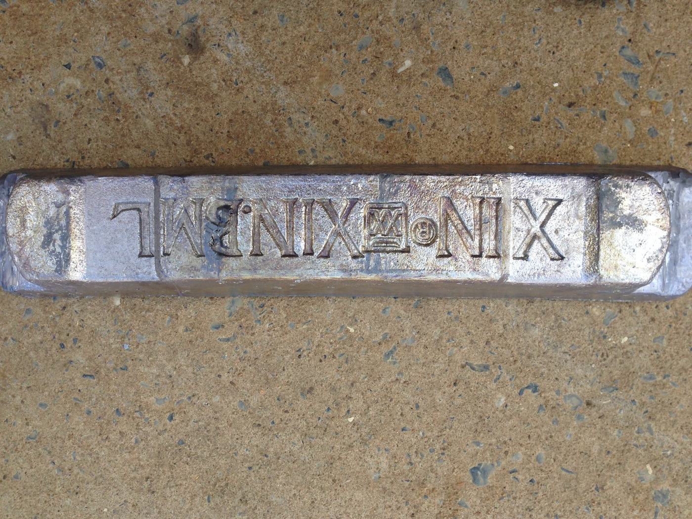 XIN XIN.BML brand stamp on a pure lead ingot
